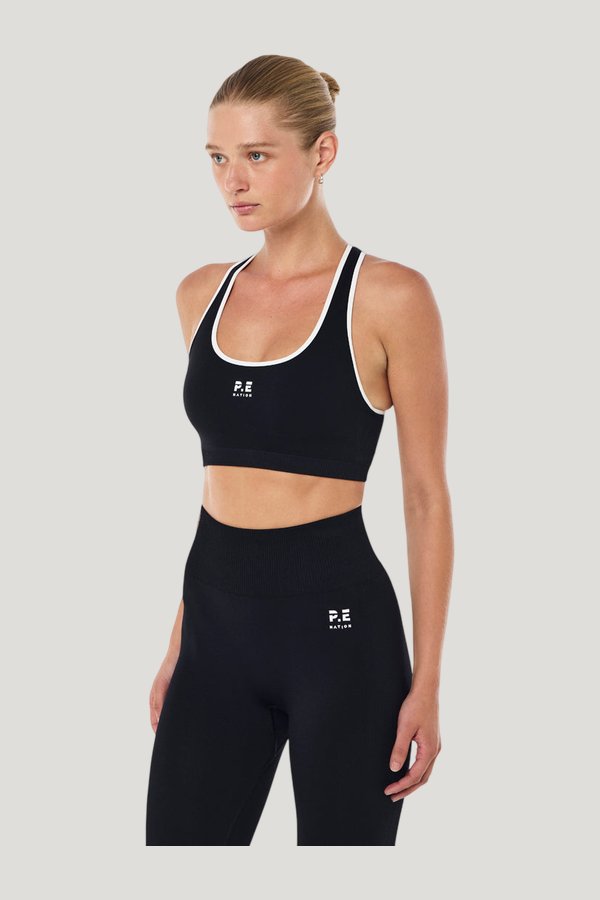 Adaption Seamless Sports Bra In Black & Optic — model side